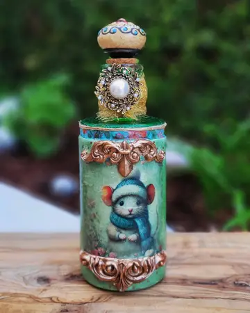 Mint green votive painted with a small bear and finished with an ornate sculpted topper
