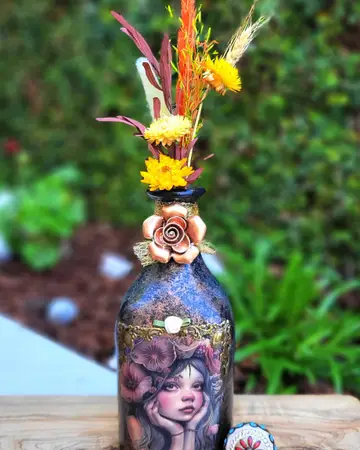 Violet bottle embellished with sculpted roses and crowned with a feather plume