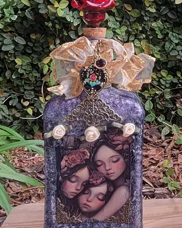 Lavender bottle decorated with three faces and sculpted roses