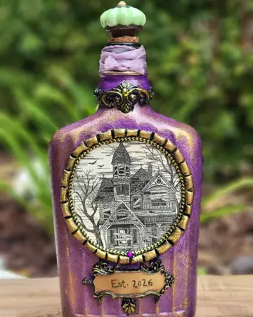 Purple bottle with an architectural illustration set in a gold frame