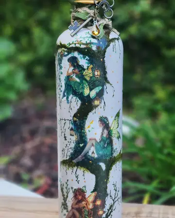 Bottle painted with a woodland scene in deep greens