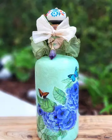 Pale green bottle painted with hydrangeas and butterflies