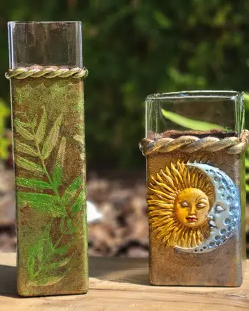 Glass votives decorated with a pressed leaf and a sun face