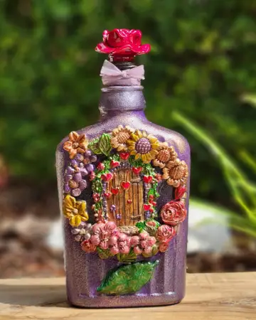 Bottle heavily embellished with sculpted pink flowers and beading
