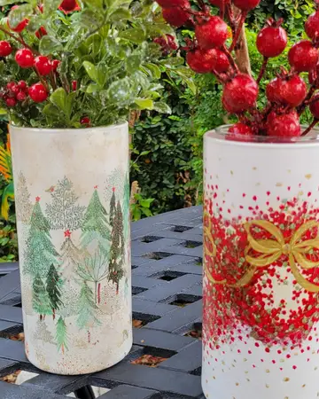 Painted vases holding red berry stems