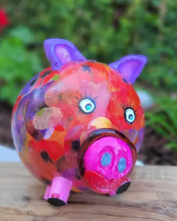 Piggy bank painted in bright collage-like colours