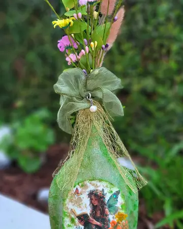 Bottle wrapped in green organza over a painted woodland panel