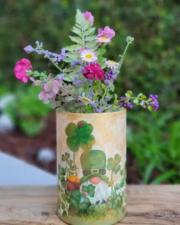 Small painted vase holding cut garden flowers